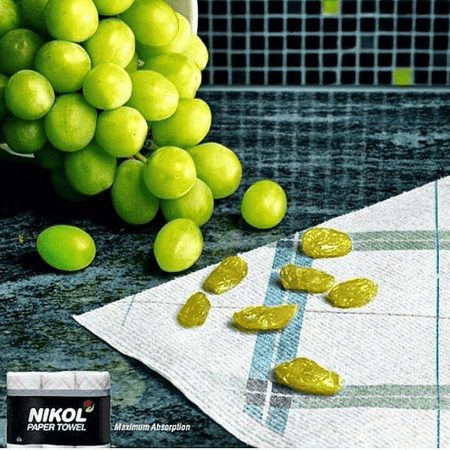 Nikol Paper Towels Ad that shows dried grapes, implying it sucked the moisture out of them to turn them into raisins